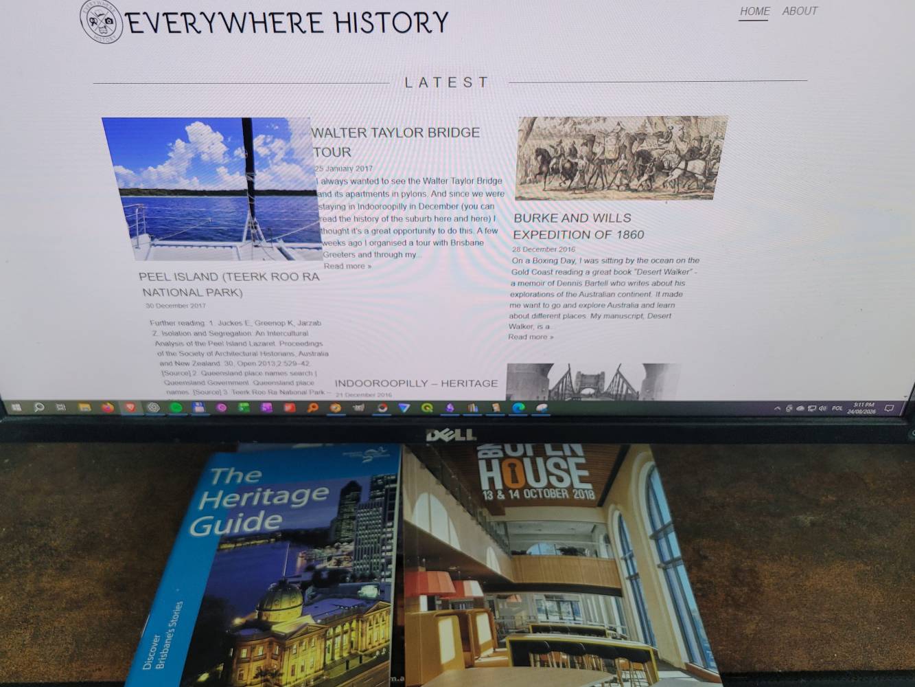 Original EverywhereHistory blog displayed on a computer screen above Brisbane heritage guides and Open House publications.